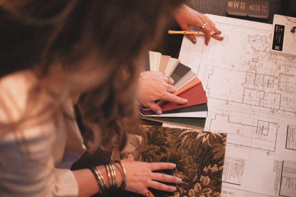 Crafting Captivating Headlines: Your awesome post title goes here Designer consulting blueprints with fabric and color samples for interior project.